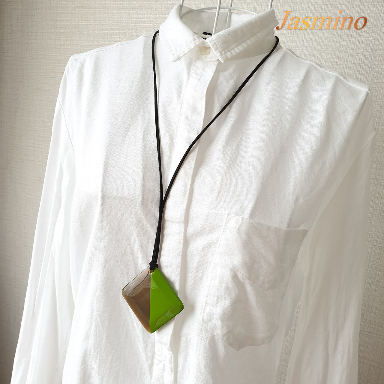 lozenge pendant is designed with the left half painted lime and the right half is natural buffalo horn on the light background, a unique gift for her