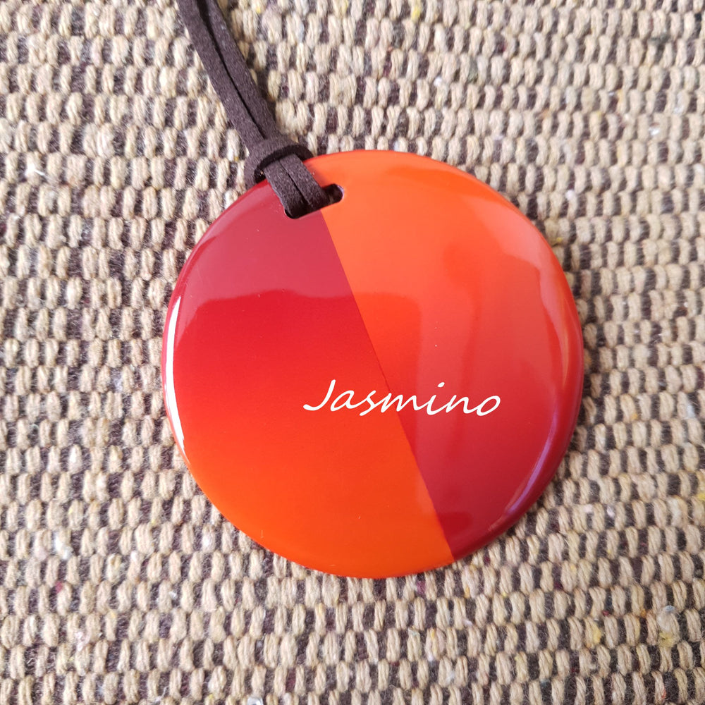 
                  
                    round red maple lacquer horn pendant on the light background, impressive gift for your friend
                  
                