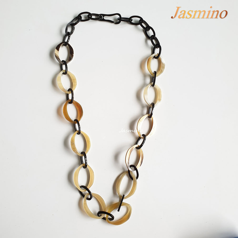
                  
                    natural horn necklace on the light background, unique gift for your friend
                  
                