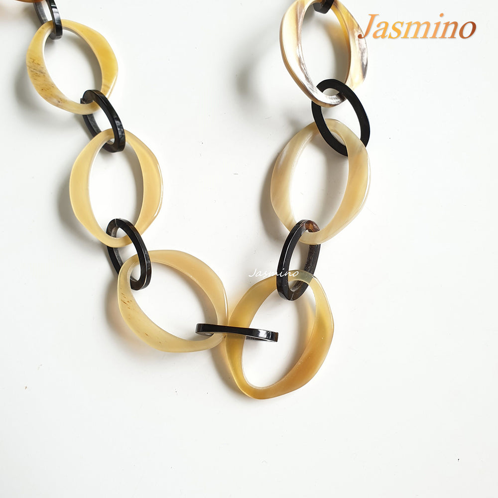 
                  
                    natural horn necklace on the light background, unique gift for your friend
                  
                