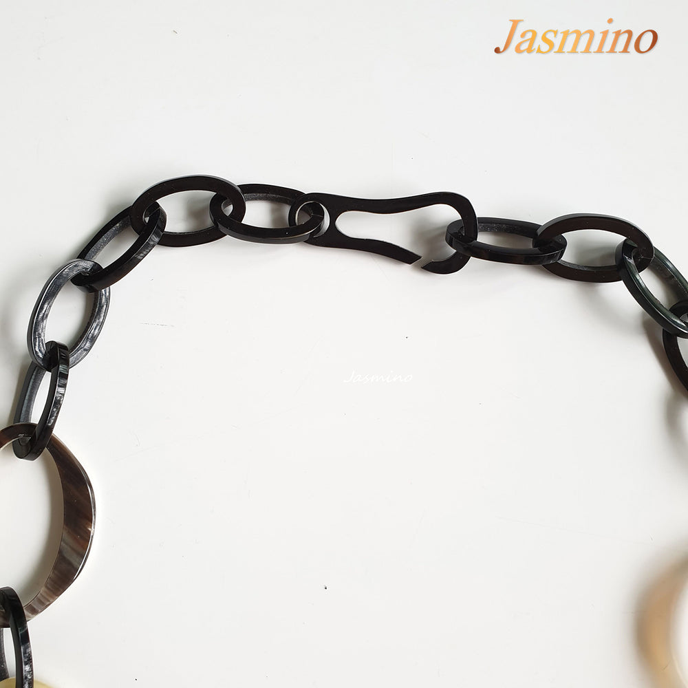 
                  
                    natural horn necklace on the light background, unique gift for your friend
                  
                