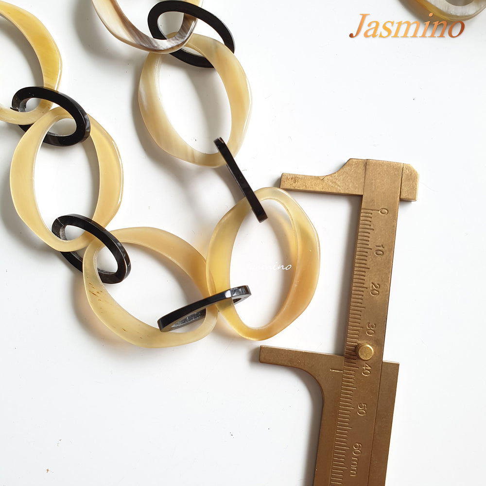 
                  
                    natural horn necklace on the light background, unique gift for your friend
                  
                