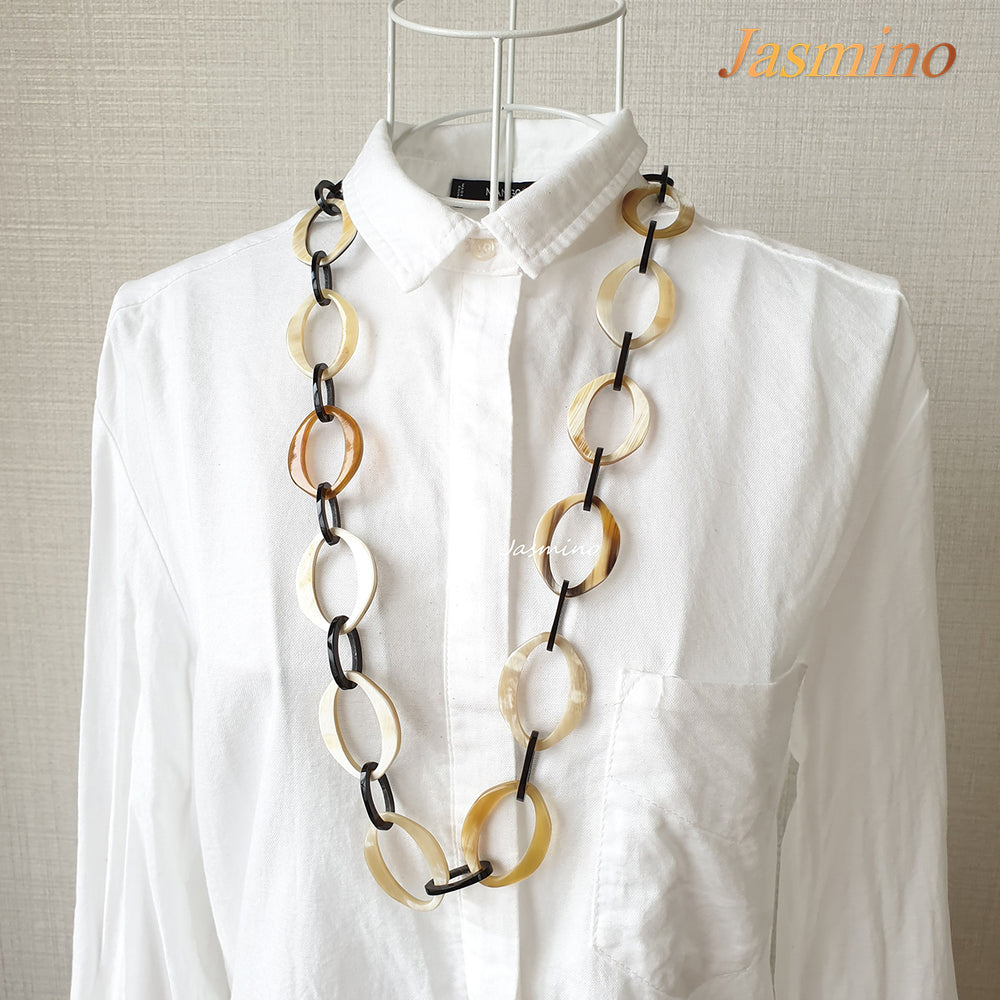 
                  
                    natural horn necklace on the light background, unique gift for your friend
                  
                