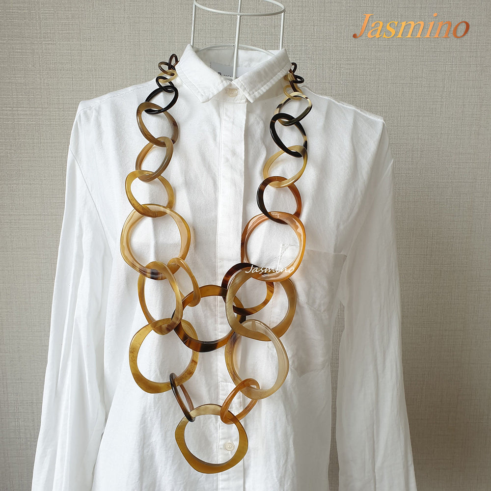 
                  
                    natural horn necklace on the light background, unique gift for your friend
                  
                