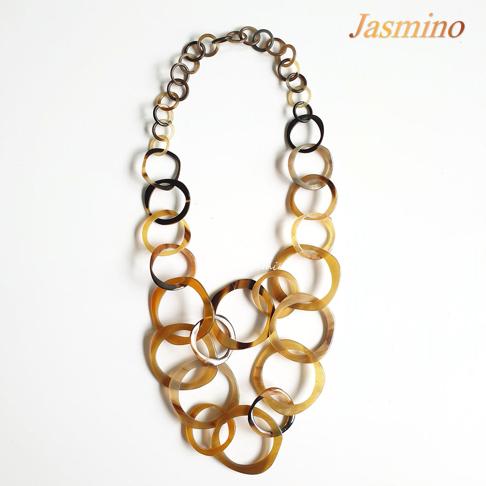 
                  
                    natural horn necklace on the light background, unique gift for your friend
                  
                