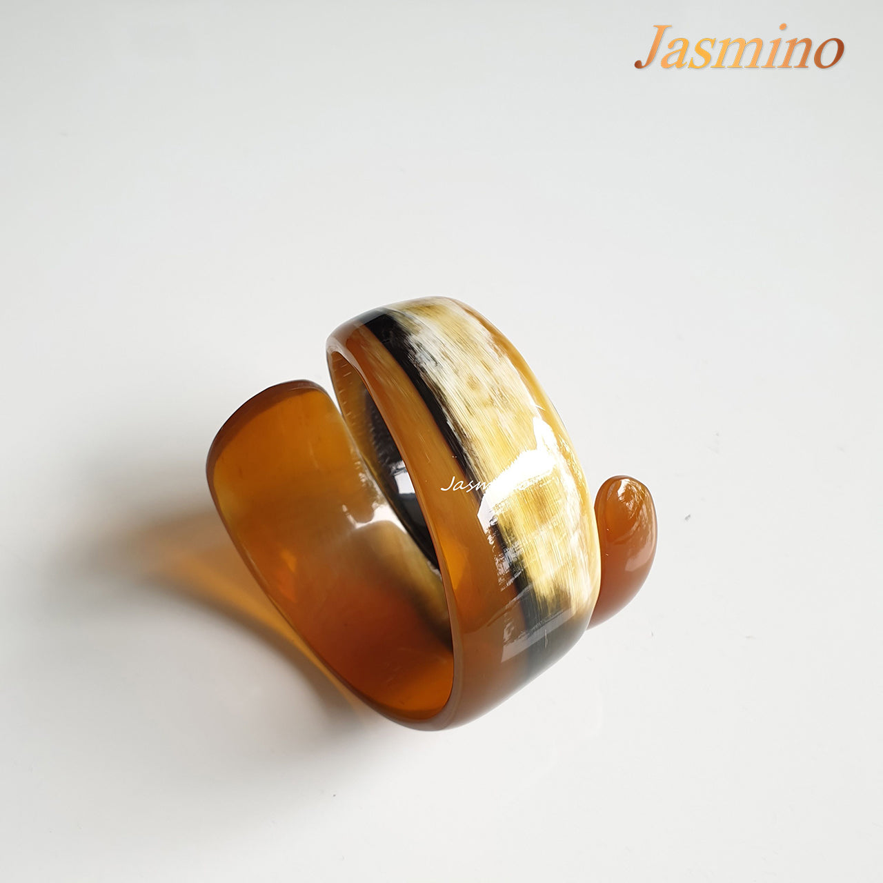 natural horn snake cuff bracelet on the light background, unique gift for your friend