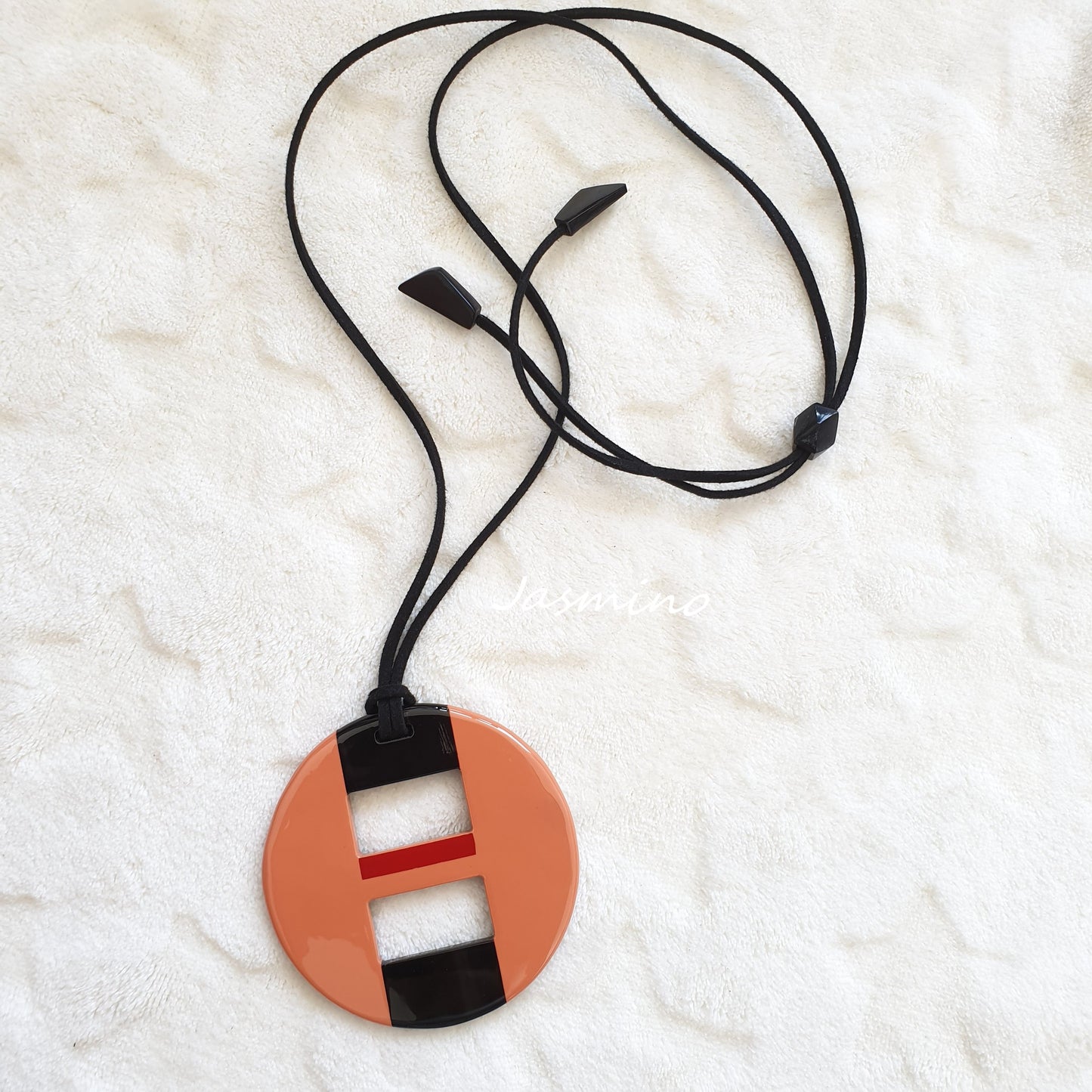 round salmon lacquer pendant on the light background, impressive gift for her