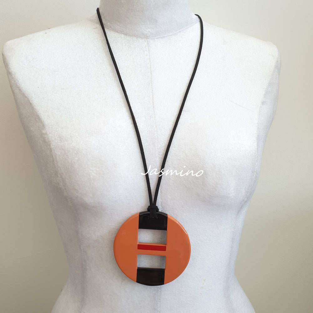 
                  
                    round salmon lacquer pendant on the light background, impressive gift for her
                  
                