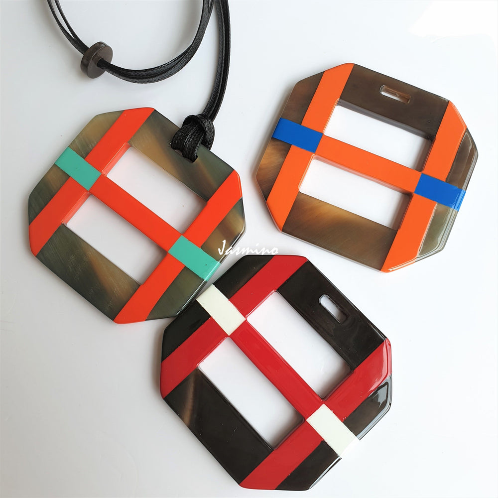 
                  
                    three unique handmade Christmas square pendant necklaces feature black, brown, red, and orange in natural buffalo horn 
                  
                