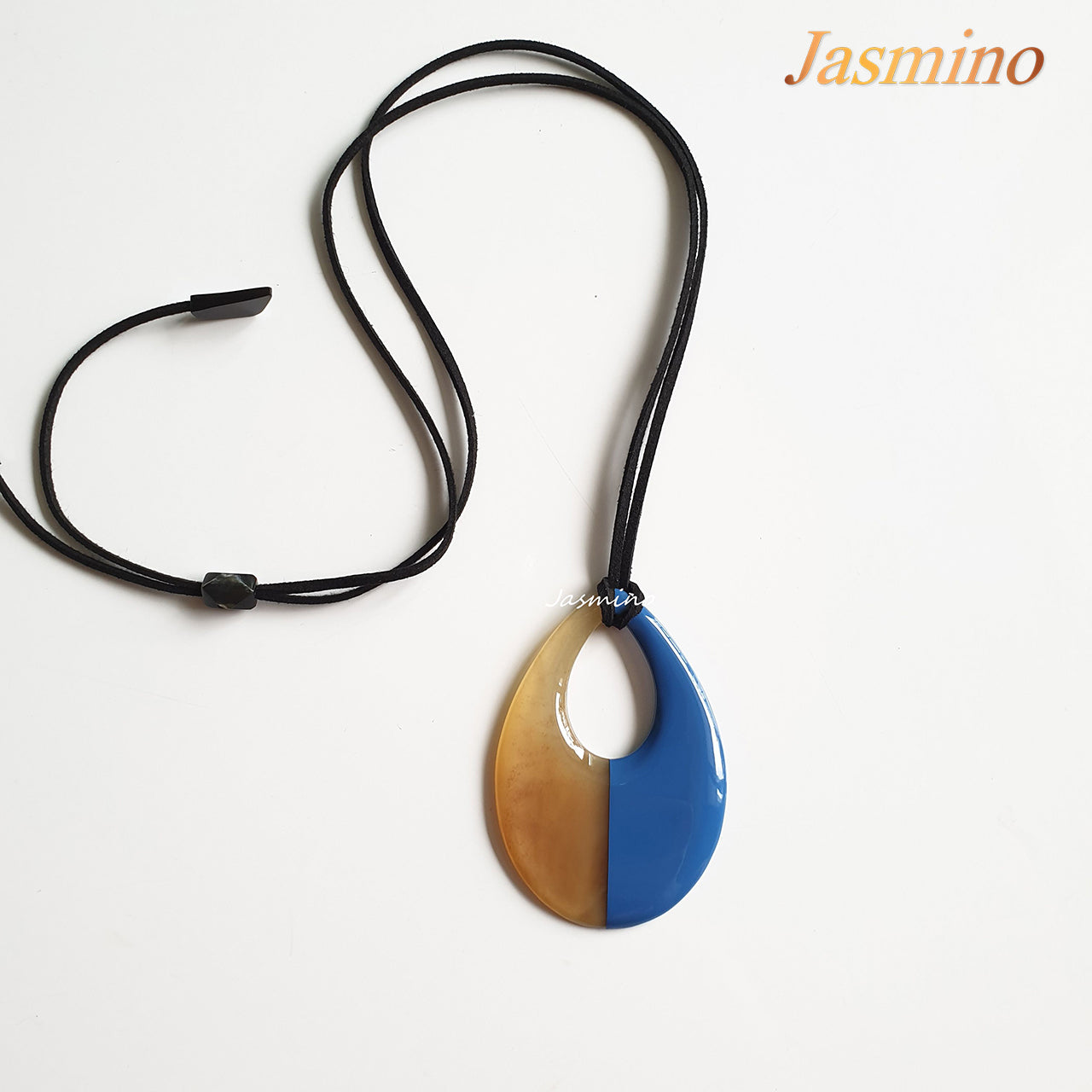 blue teardrop-shaped pendant on the light background, impressive gift for her