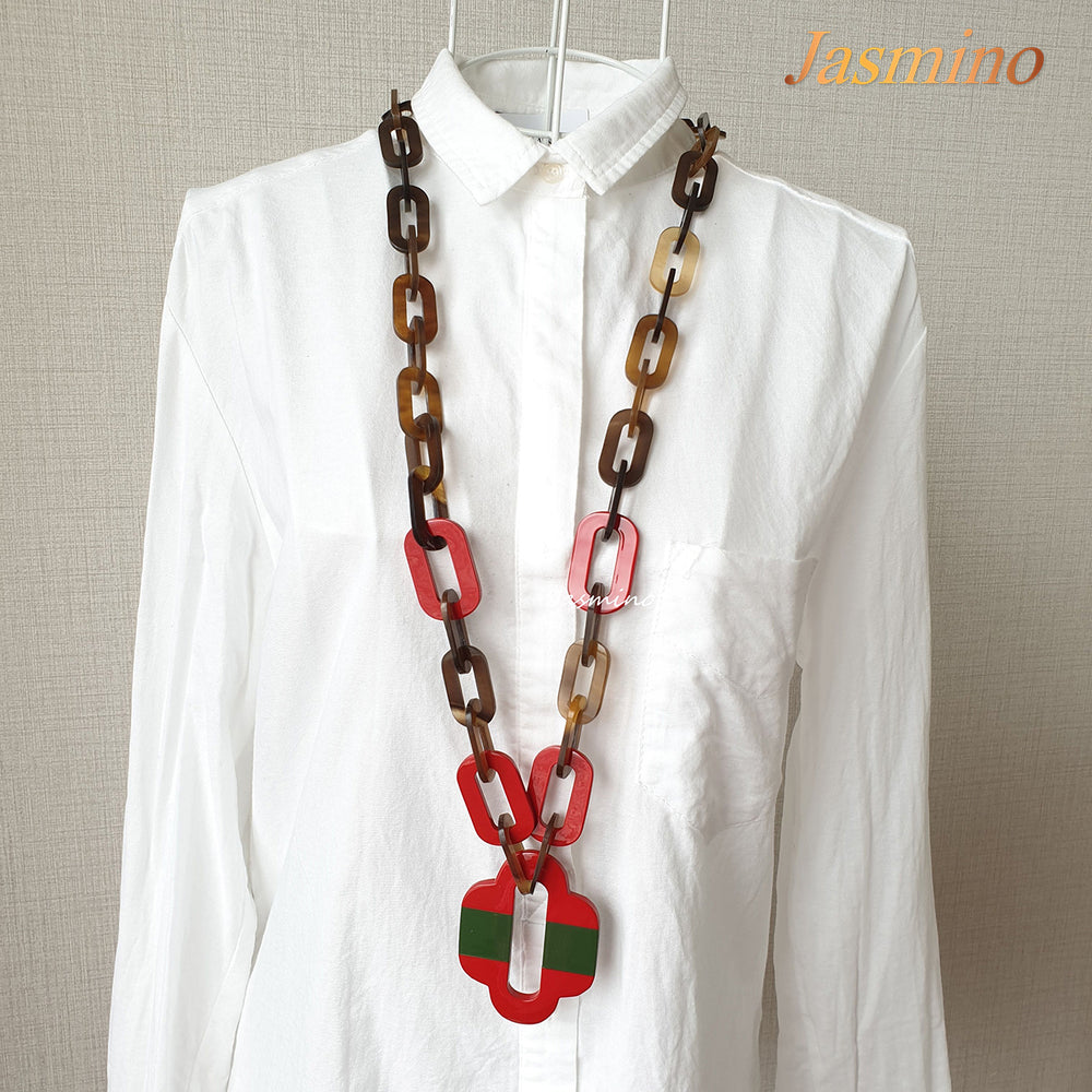 
                  
                    lacquer buffalo horn necklace with trendy flame scarlet natural horn pendant in natural light
                  
                