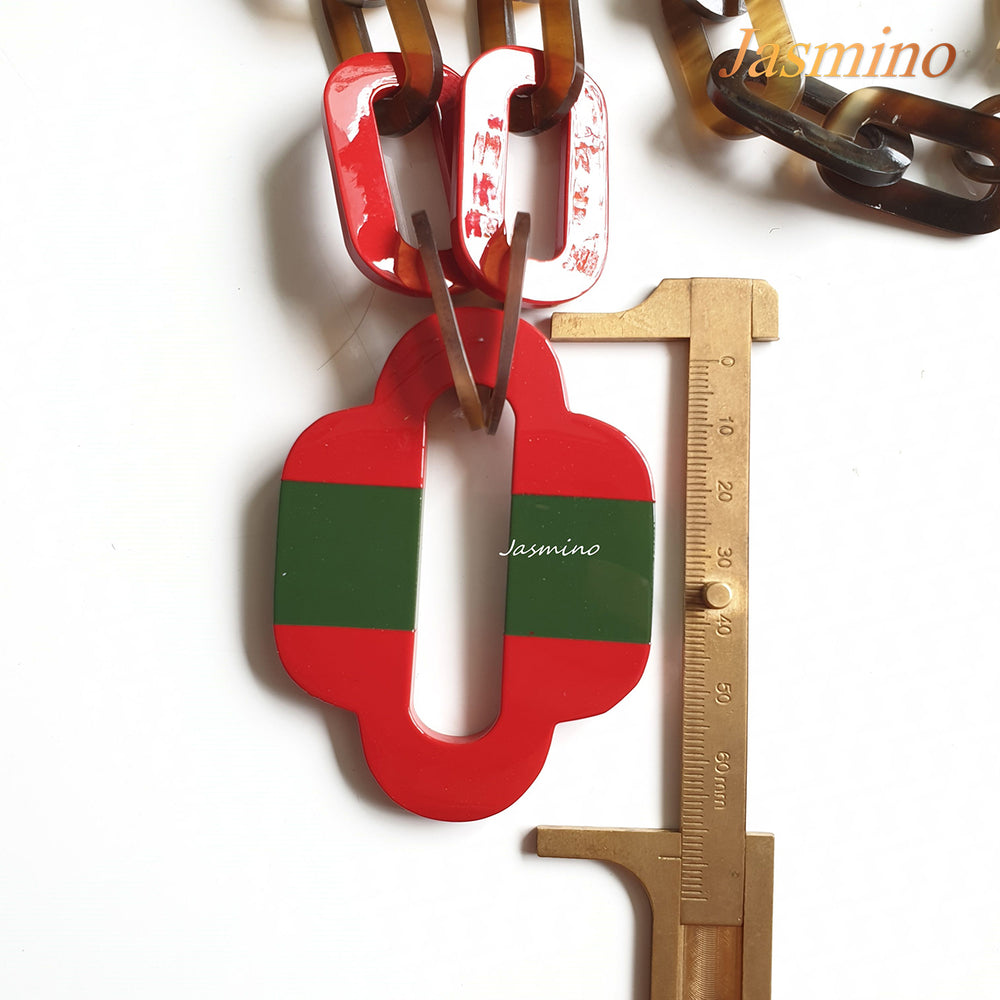 
                  
                    lacquer buffalo horn necklace with trendy flame scarlet natural horn pendant in natural light
                  
                