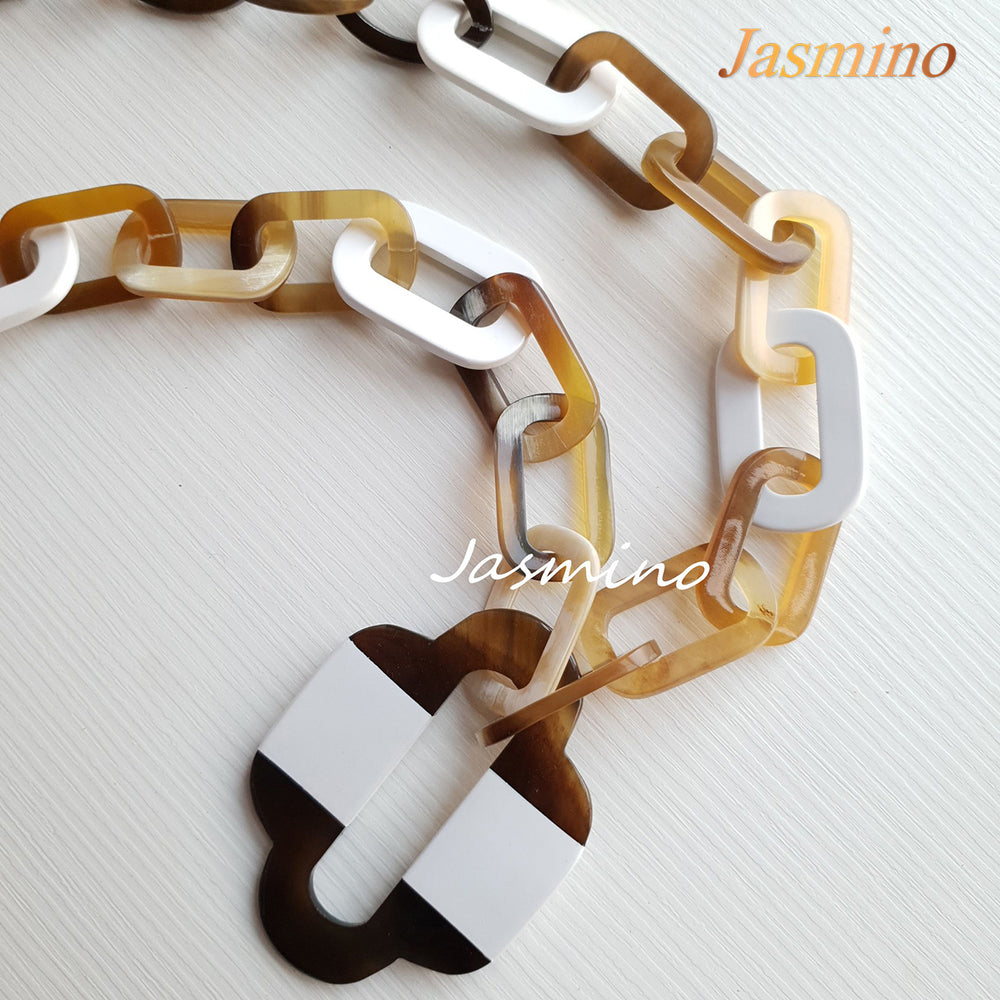 
                  
                    lacquer buffalo horn necklace with trendy brilliant white natural horn pendant in natural light
                  
                