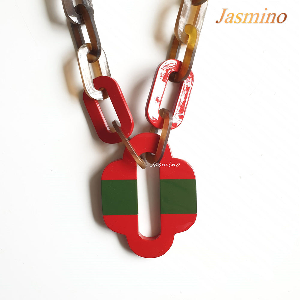 
                  
                    lacquer buffalo horn necklace with trendy flame scarlet natural horn pendant in natural light
                  
                