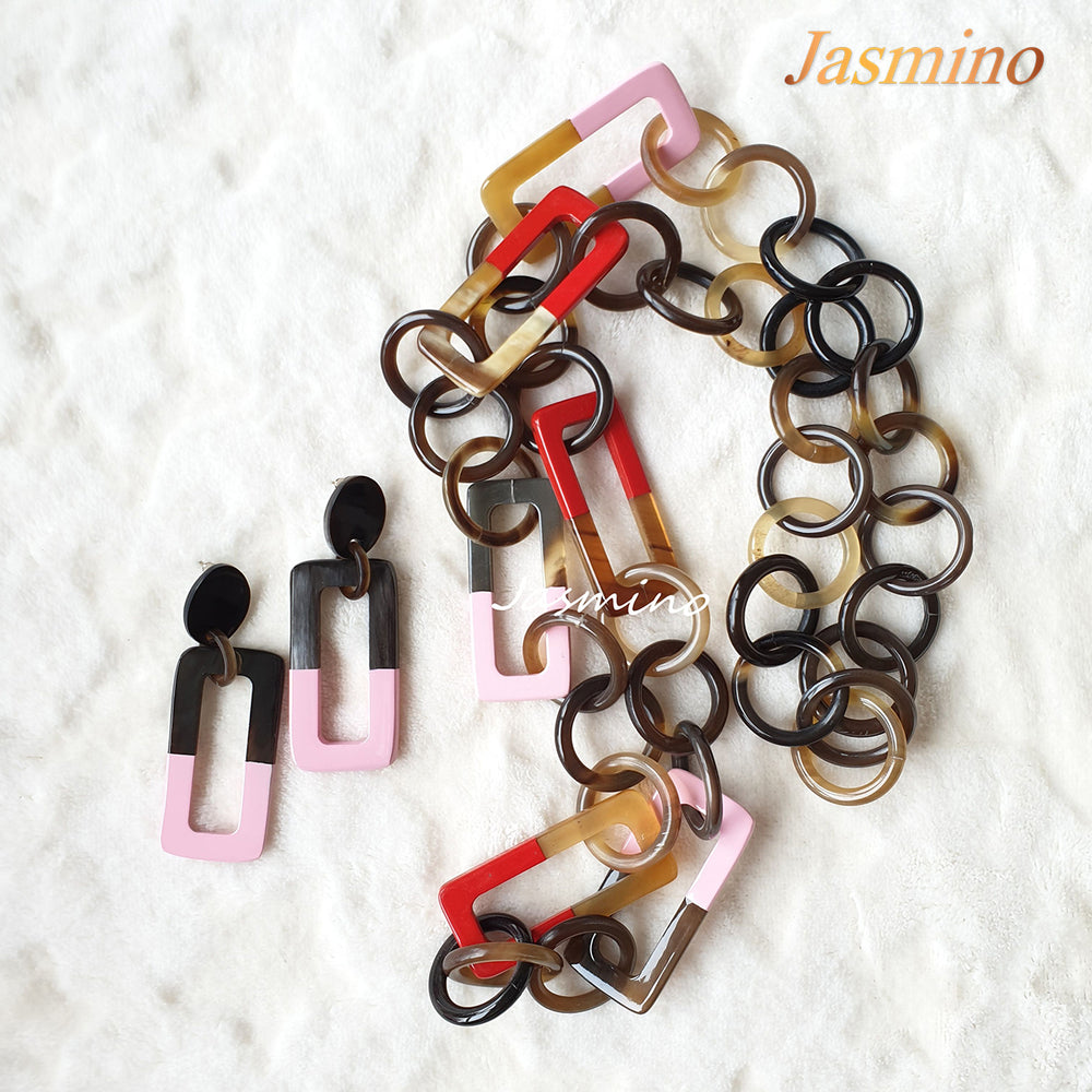 
                  
                    A set of handmade earrings and wide chain necklaces features bright colours for men and women
                  
                