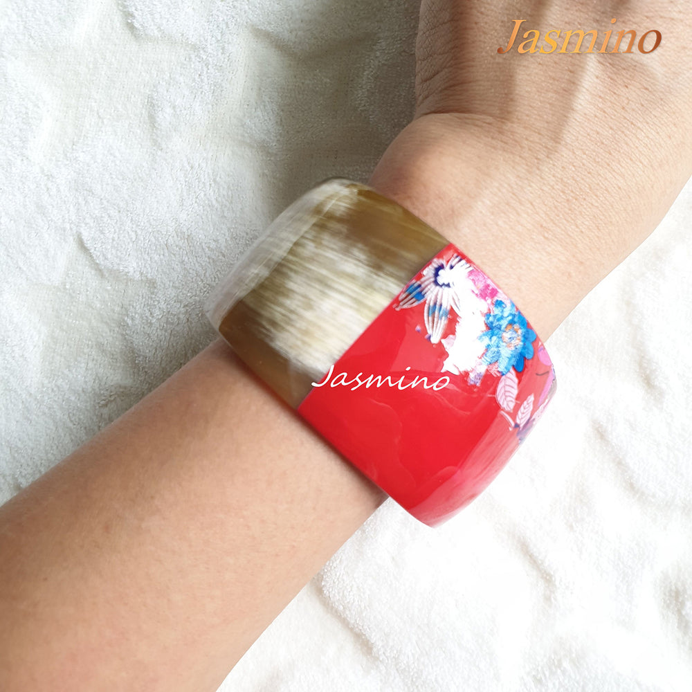 
                  
                    A model is wearing the bracelet designed with half natural horn and half flame scarlet lacquer and shaped by small flowers, unique gift for her
                  
                
