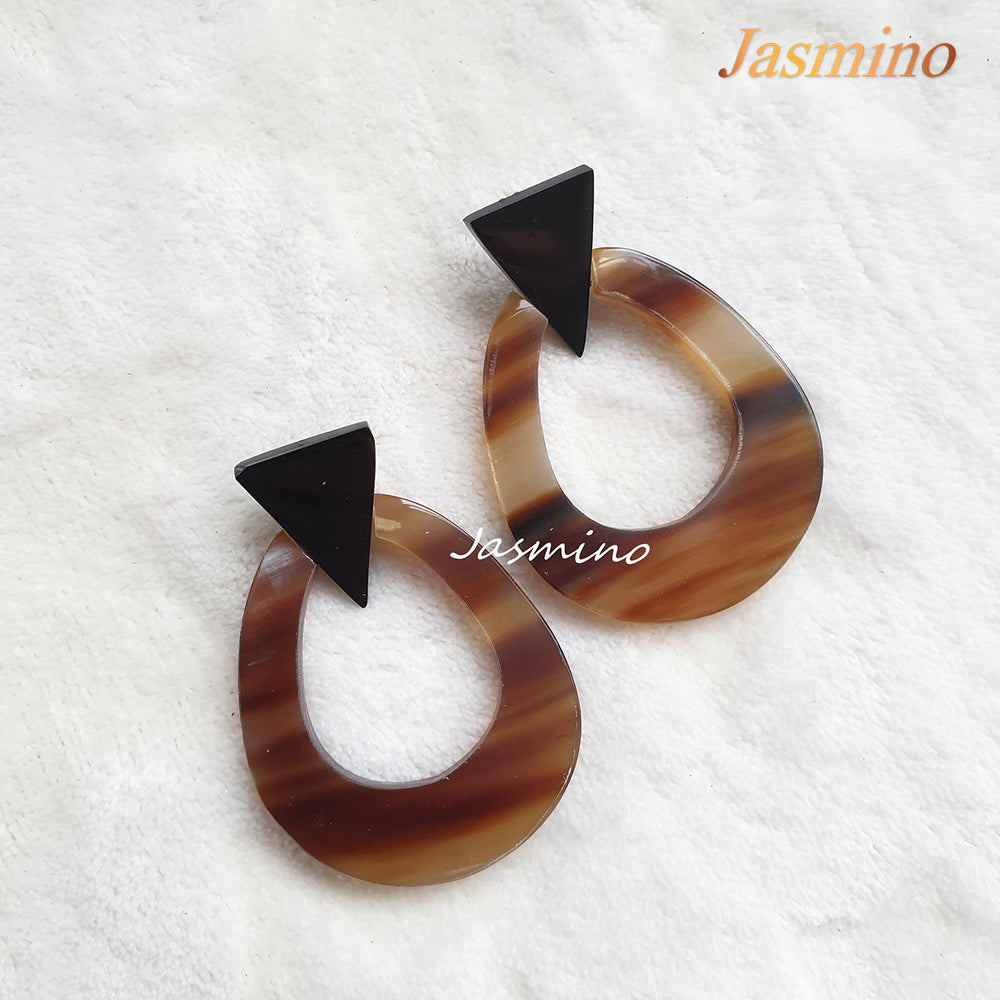 
                  
                    Handmade oval earrings are made of natural buffalo horn with an ombre color in the natural light
                  
                