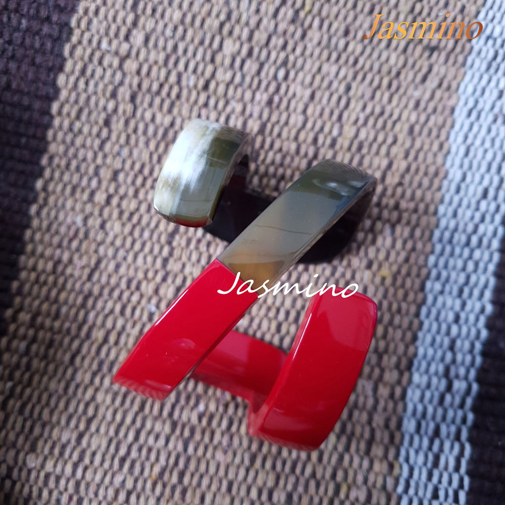 
                  
                    A set of three unique handmade N-shaped red cuff bracelets in natural buffalo horn in natural buffalo horn for women 
                  
                
