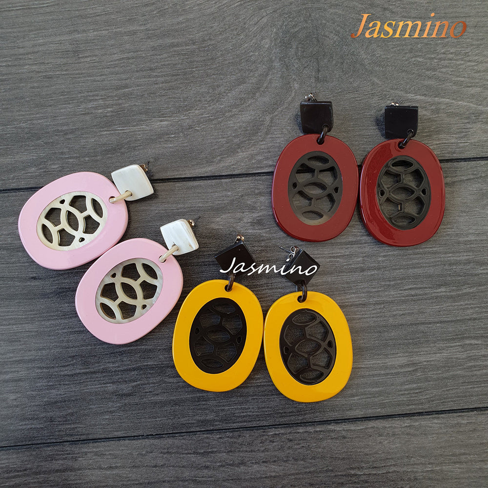 
                  
                    A set of three pairs of earrings features red, pink, and yellow color made of natural buffalo horn
                  
                