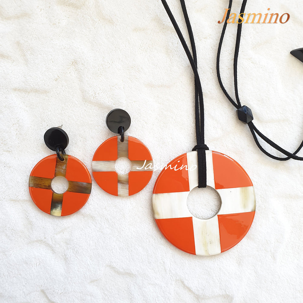 
                  
                    A set of Christmas handmade earrings features a cross and coin shape with orange and white color
                  
                