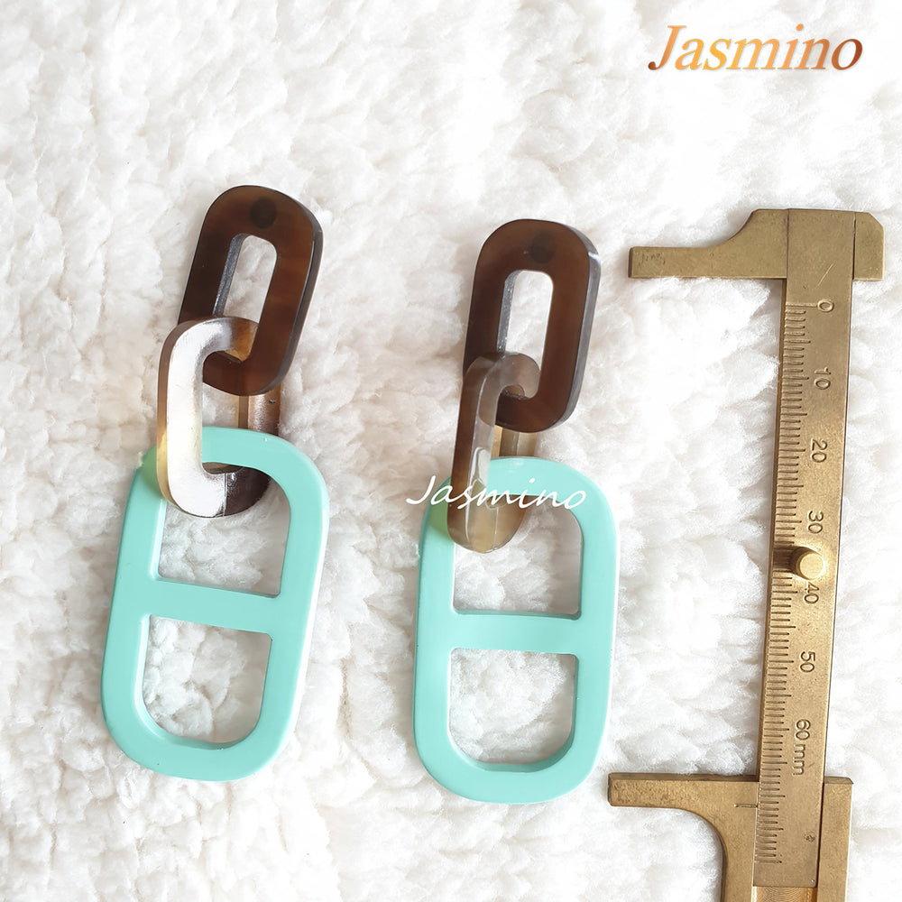 
                  
                    Jasmino unique handmade earrings feature a paperclip shape with turquoise and brown color made of natural buffalo horn
                  
                