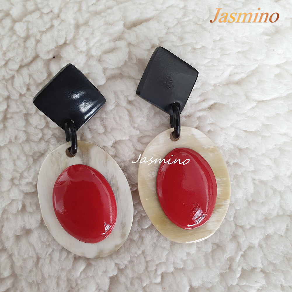
                  
                    Jasmino unique handmade Bohemian mermaid beach oval drop earrings feature red and white made of natural buffalo horn
                  
                