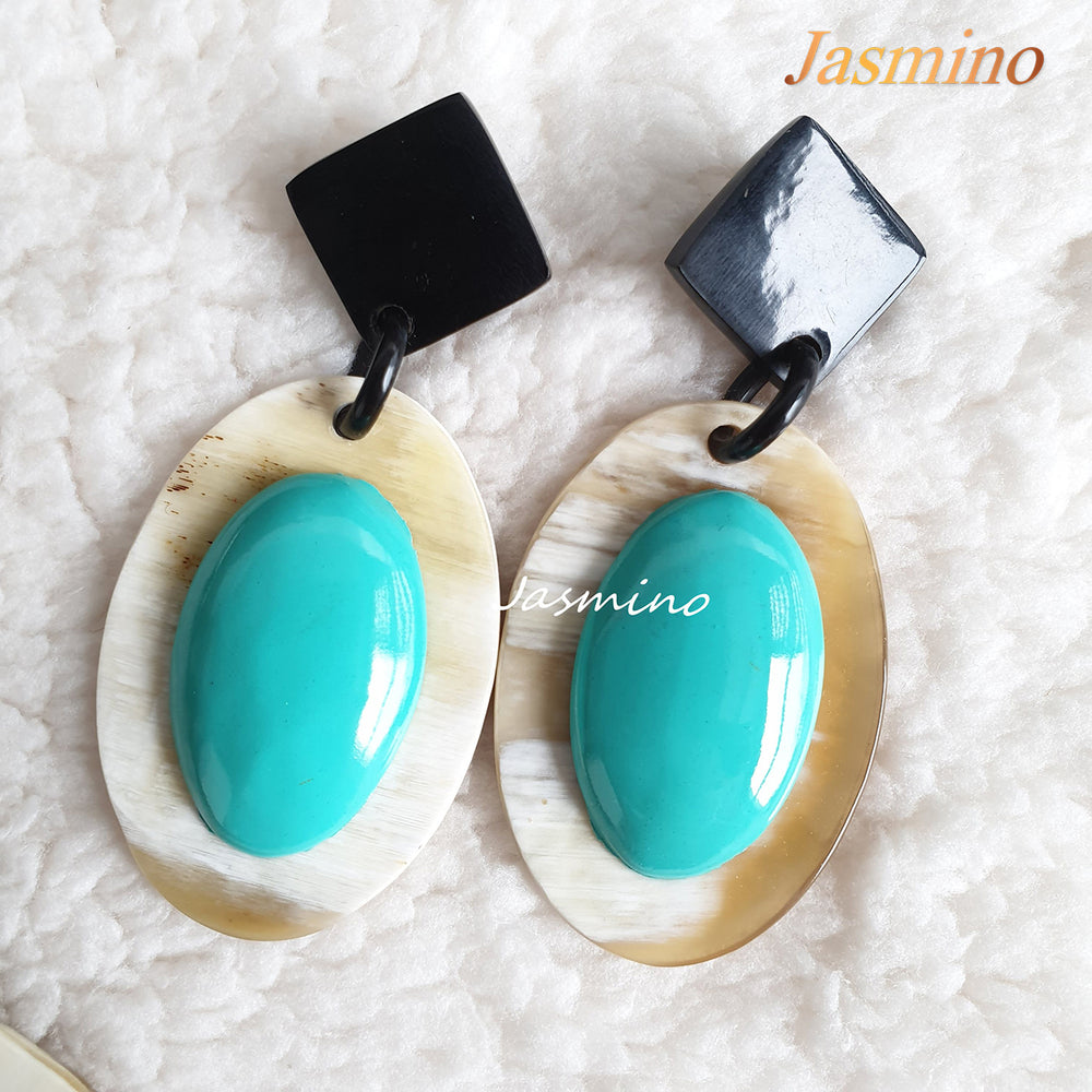 
                  
                    Jasmino unique handmade Bohemian mermaid beach oval drop earrings feature aqua and white made of natural buffalo horn
                  
                