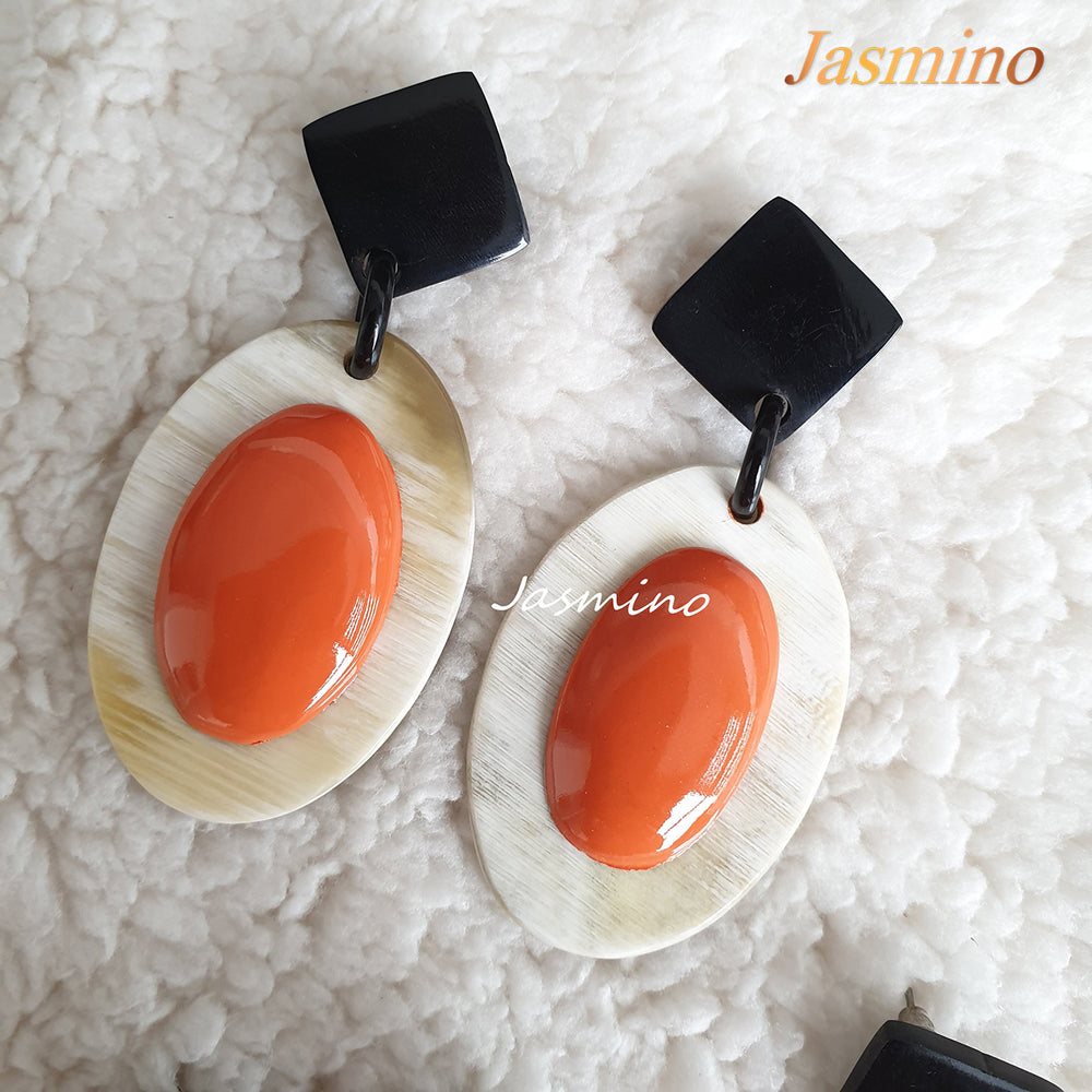 
                  
                    Jasmino unique handmade Bohemian mermaid beach oval drop earrings feature orange and white made of natural buffalo horn
                  
                