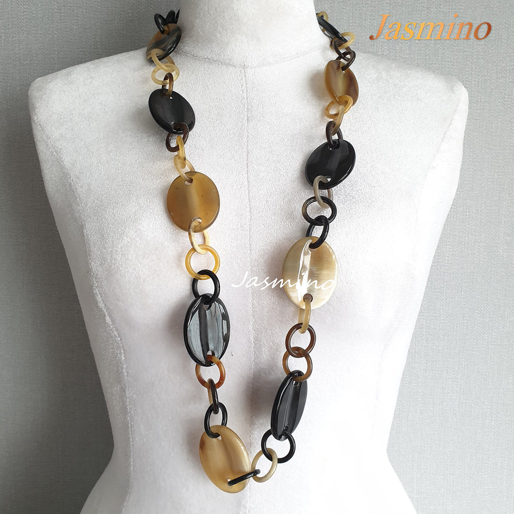 
                  
                    natural horn necklace on the light background, unique gift for your friend
                  
                