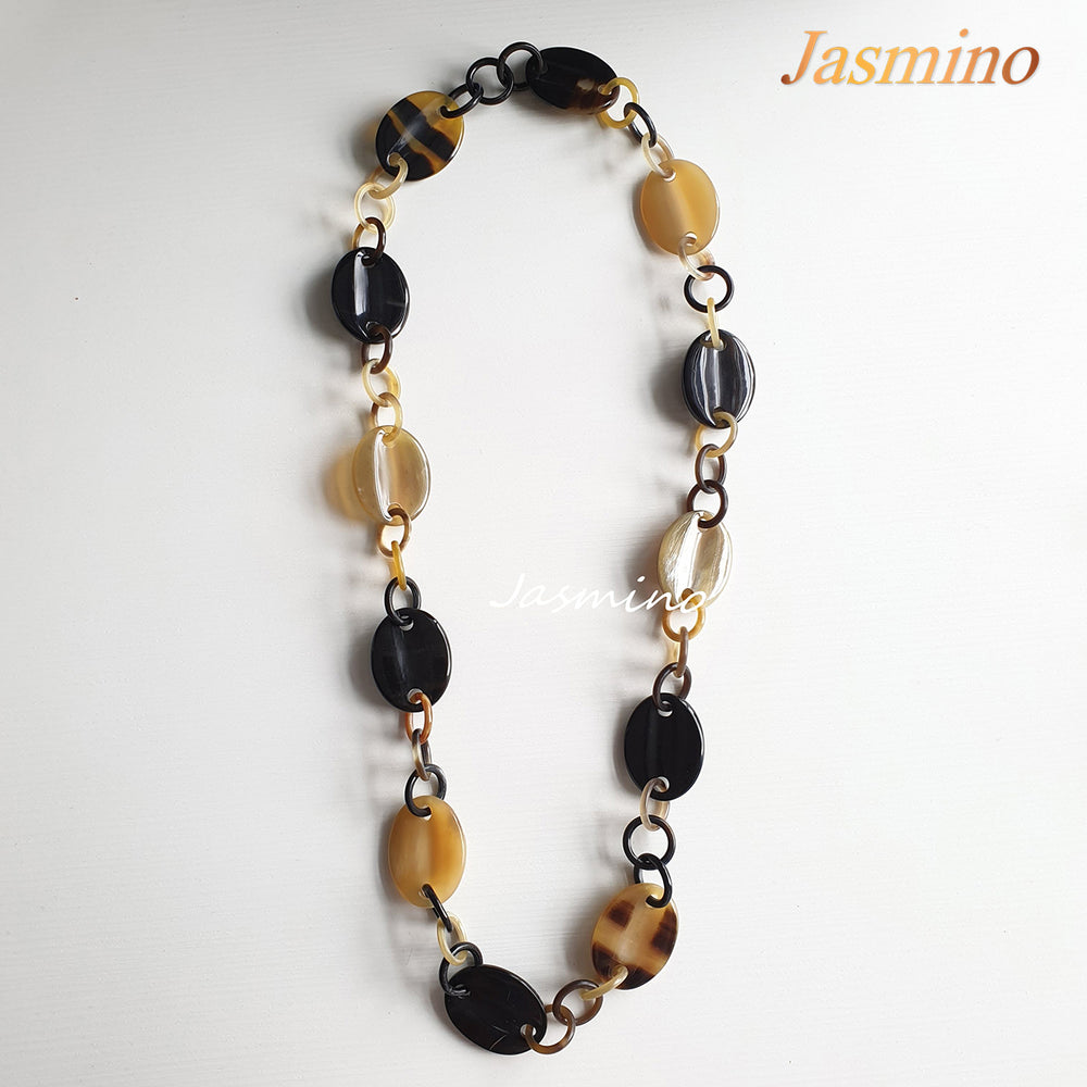 
                  
                    natural horn necklace on the light background, unique gift for your friend
                  
                