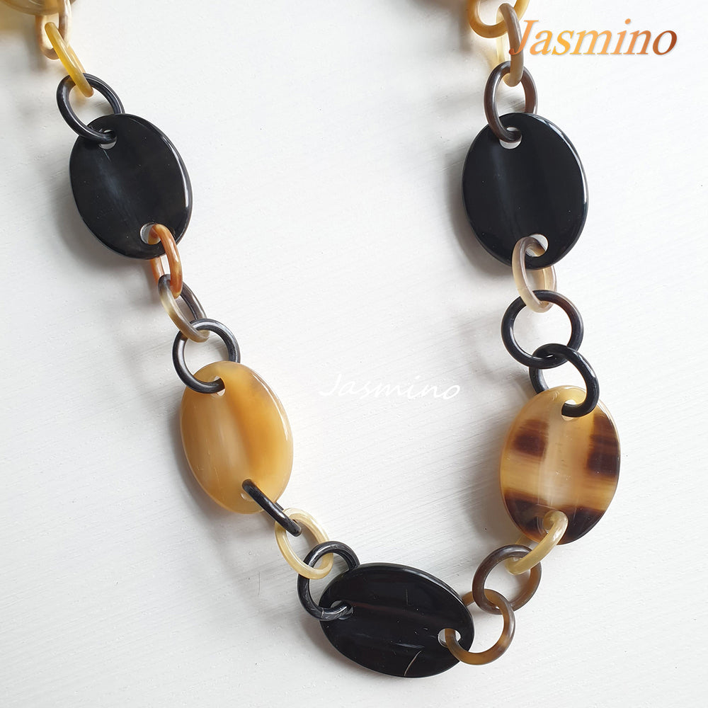 
                  
                    natural horn necklace on the light background, unique gift for your friend
                  
                