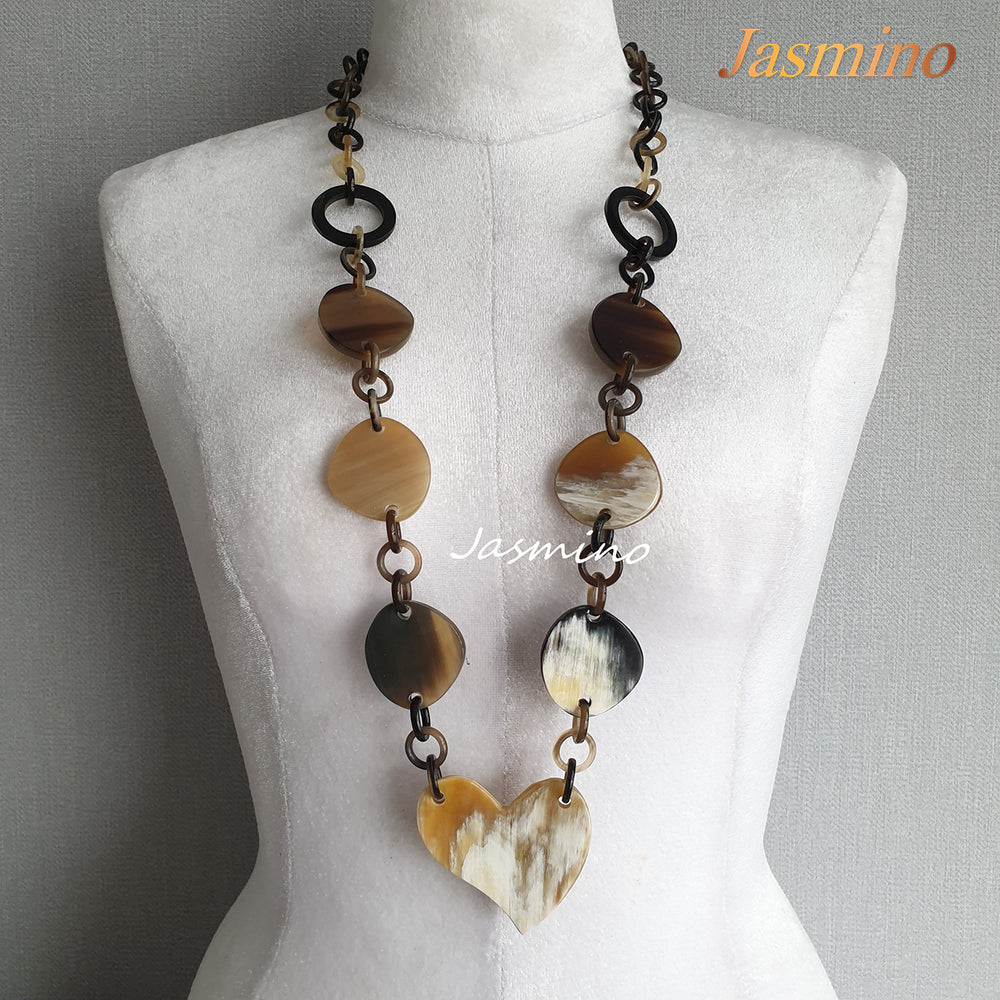 
                  
                    natural horn necklace on the light background, unique gift for your friend
                  
                