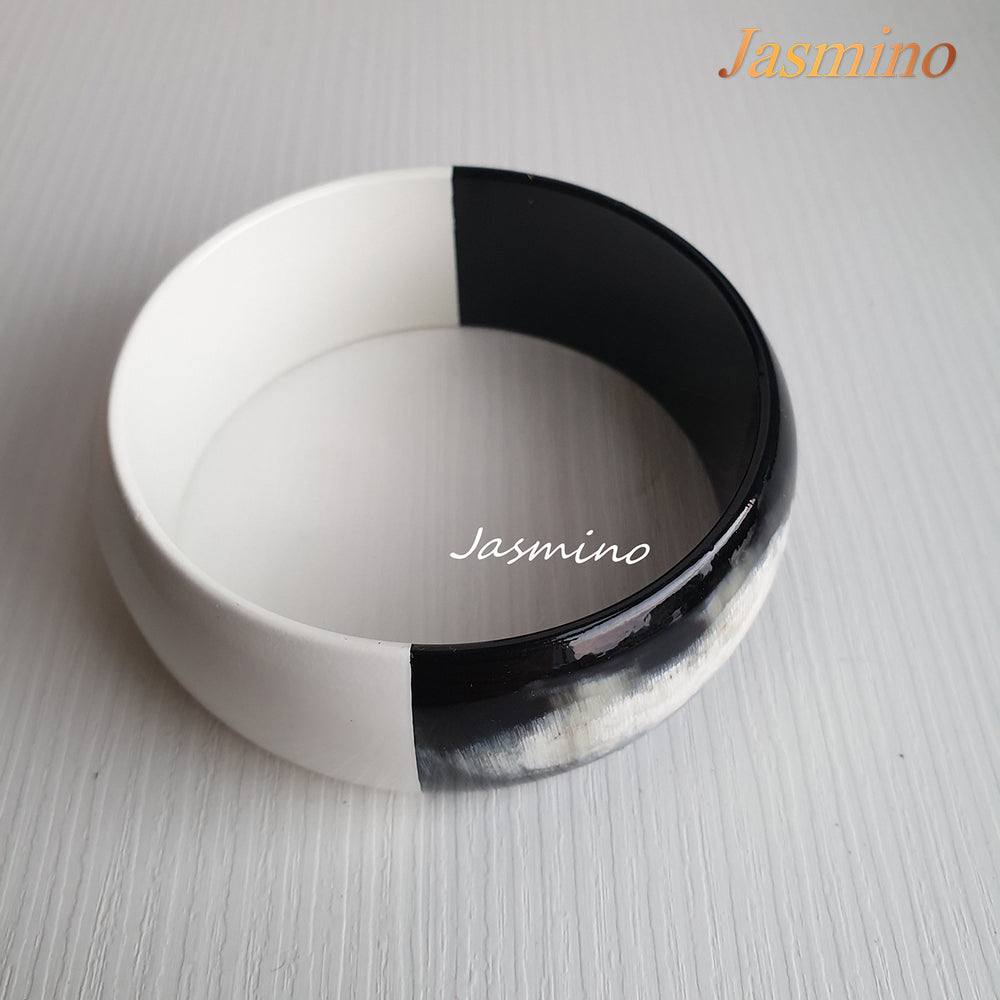 
                  
                    Buffalo horn bangle with half natural horn and half painted brilliant white on the light background, impressive gift for her
                  
                