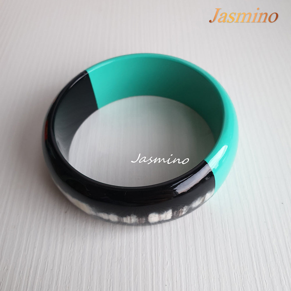 
                  
                    Buffalo horn bangle with half natural horn and half painted turquoise on the light background, impressive gift for her
                  
                