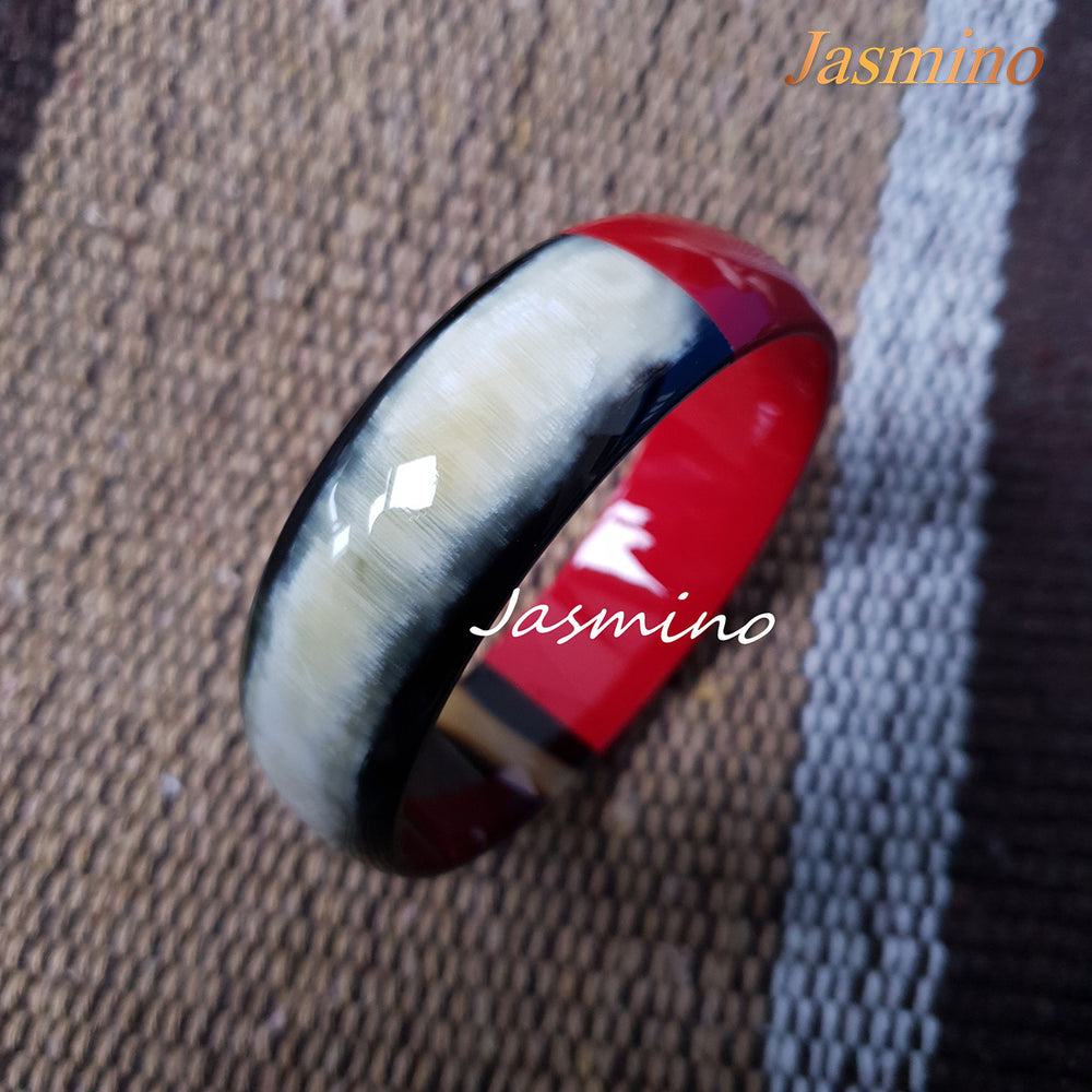 
                  
                    Buffalo horn bangle with half natural horn and half painted flame scarlet on the light background, impressive gift for her
                  
                
