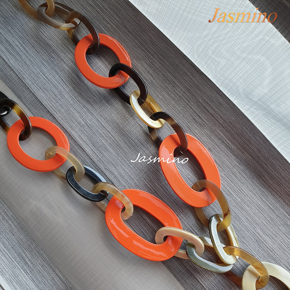 
                  
                    The necklace has several large orange peel pieces in natural light, impressive gift for her
                  
                