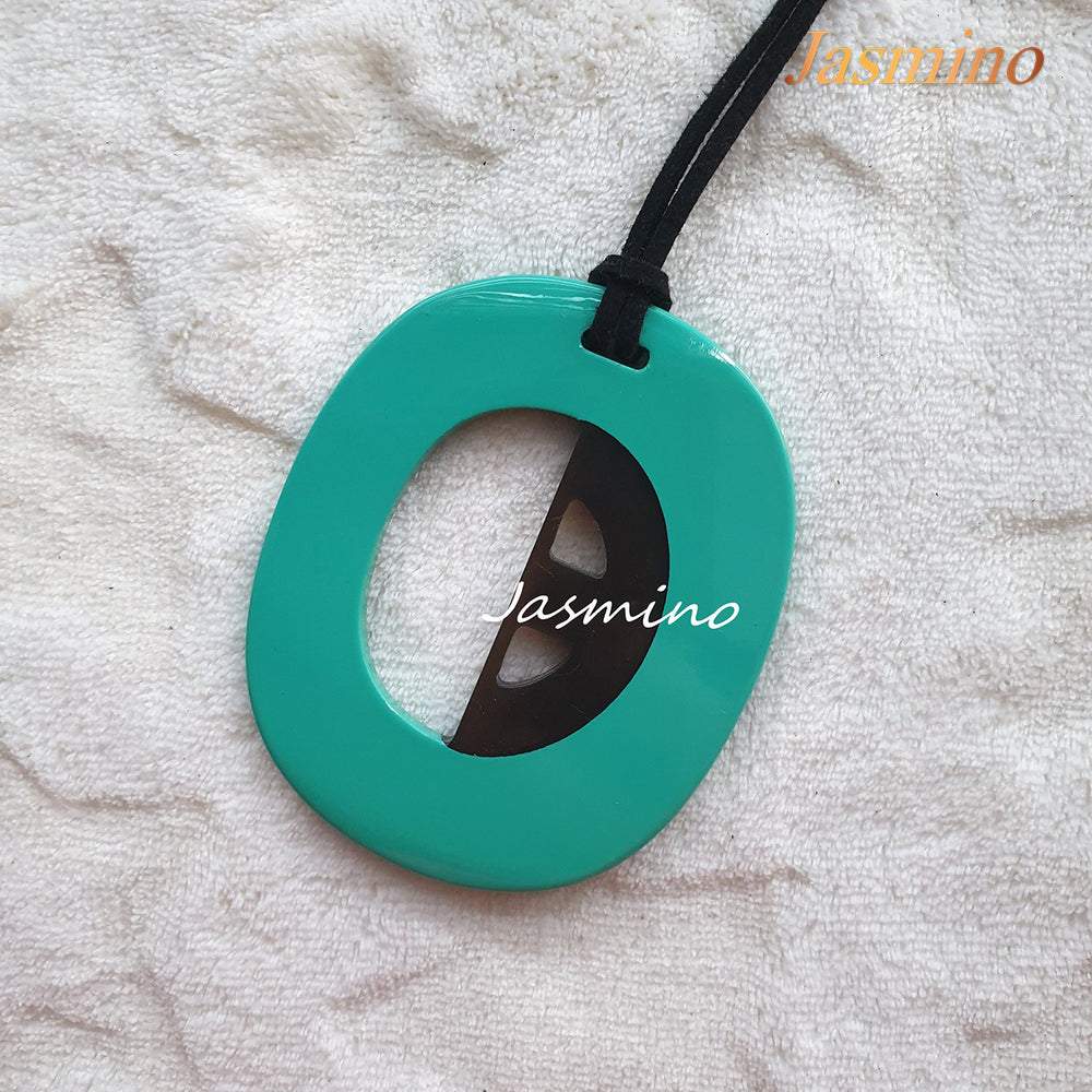 
                  
                    elliptical mint horn pendant on the light background, impressive gift for her
                  
                