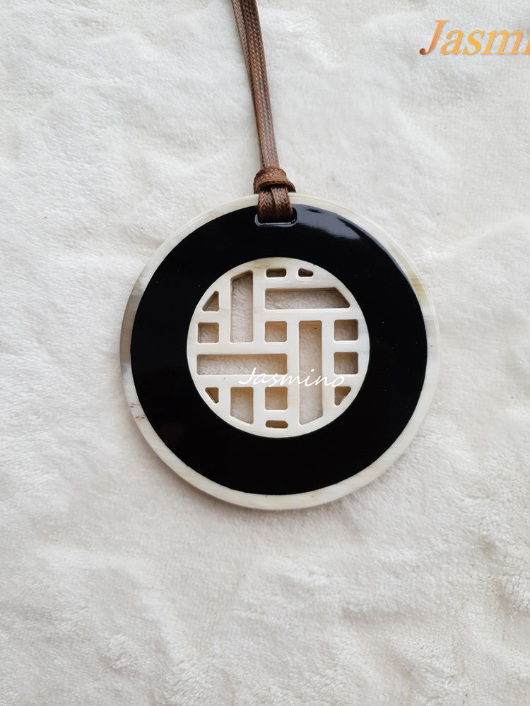 
                  
                    black lacquer pendant on the light background, impressive gift for her
                  
                
