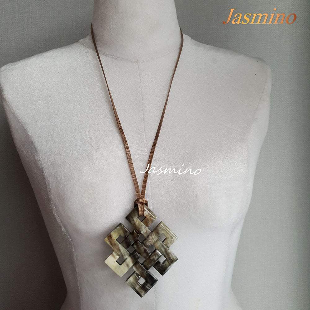 
                  
                    unique lozenge natural buffalo horn pendant on the light background, impressive gift for her
                  
                