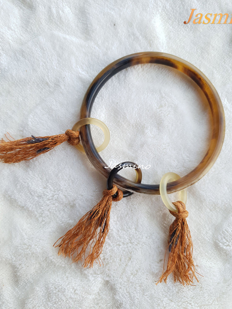 Jasmino unique handmade Bohemian Witchy thin circle bangle bracelet is detailed by brown tassels in natural buffalo horn for women's gifts