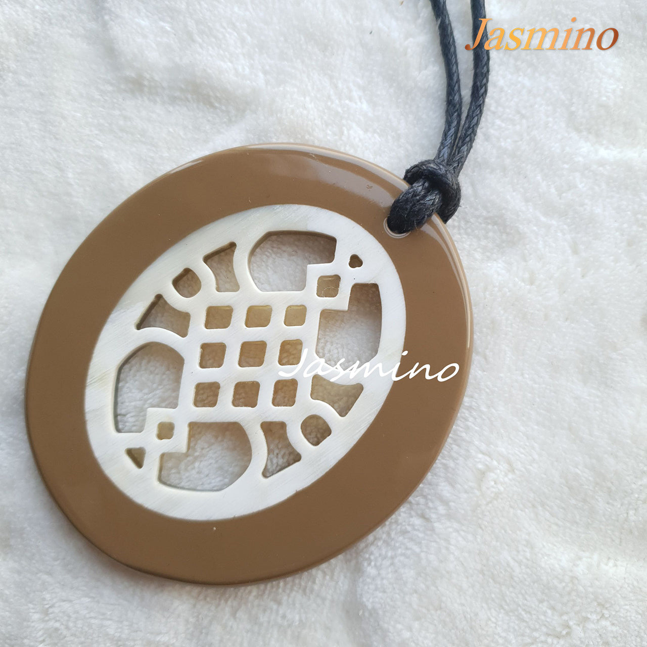 elliptical taupe lacquer pendant on the light background, impressive gift for her