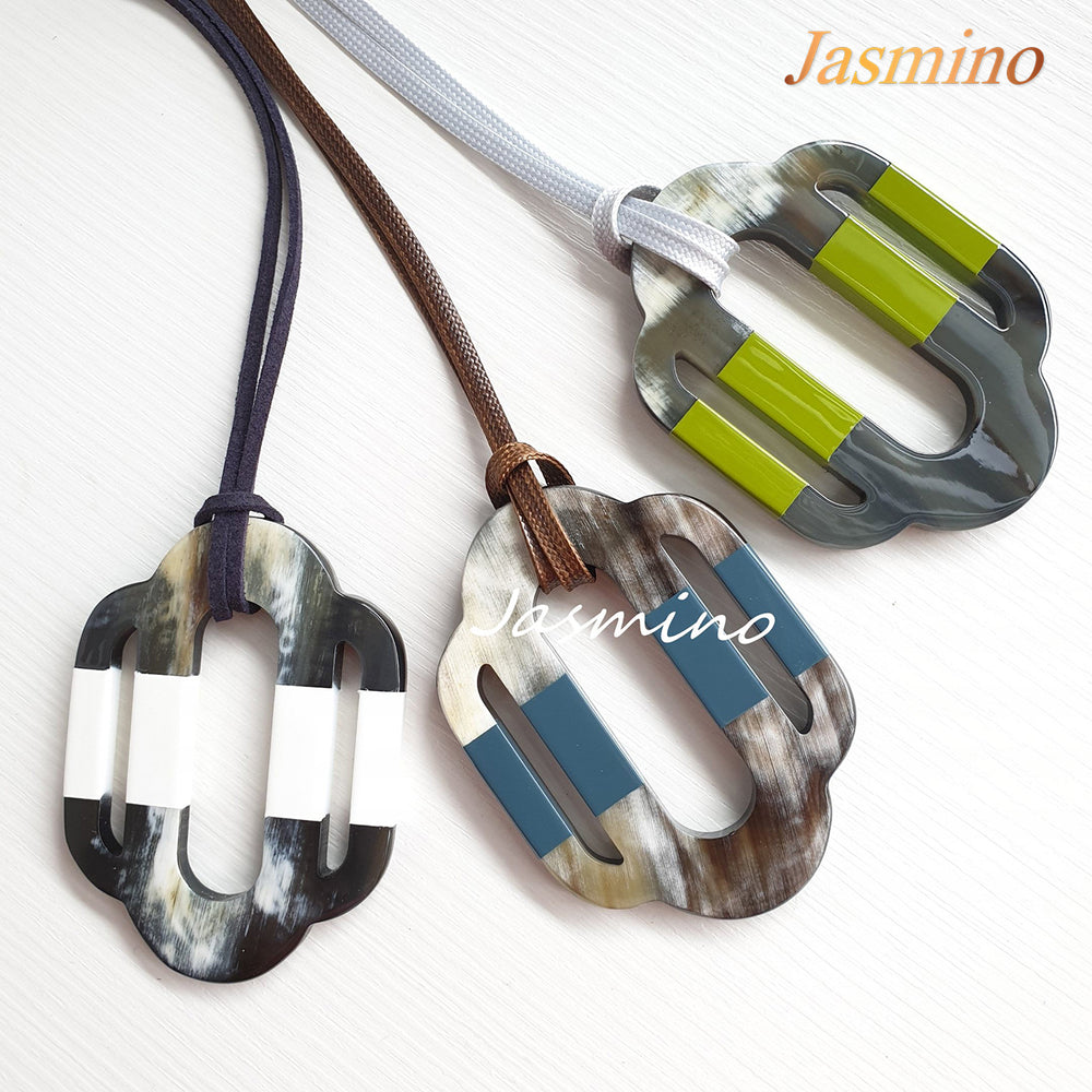 
                  
                    trendy horn pendants on the light background, impressive gift for her
                  
                