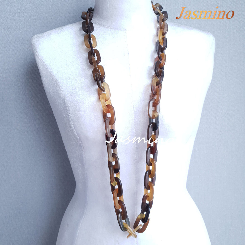 
                  
                    natural horn necklace on the light background, unique gift for your friend
                  
                