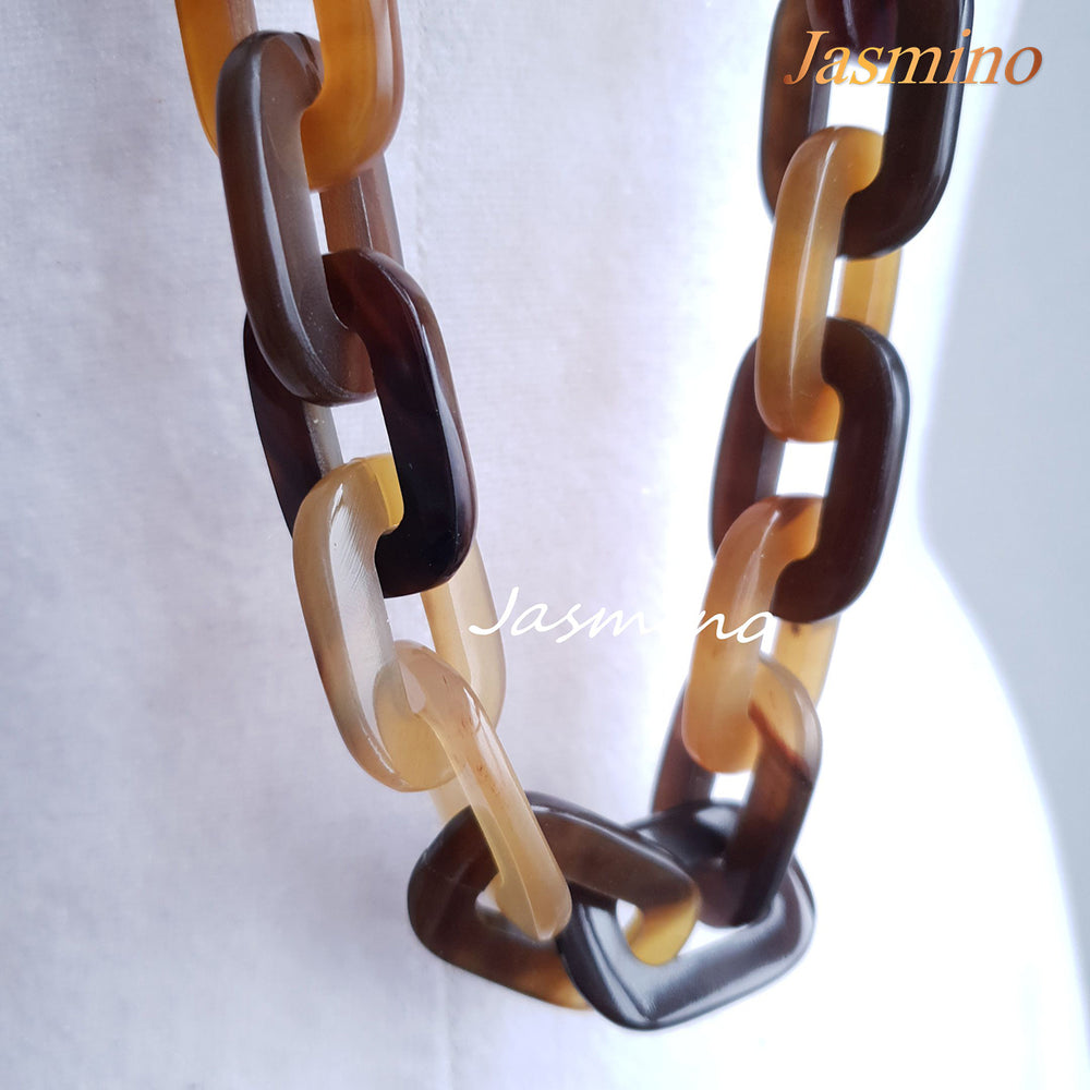 
                  
                    natural horn necklace on the light background, unique gift for your friend
                  
                
