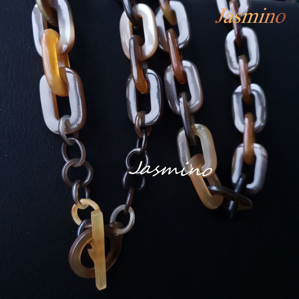 
                  
                    natural horn necklace on the light background, unique gift for your friend
                  
                