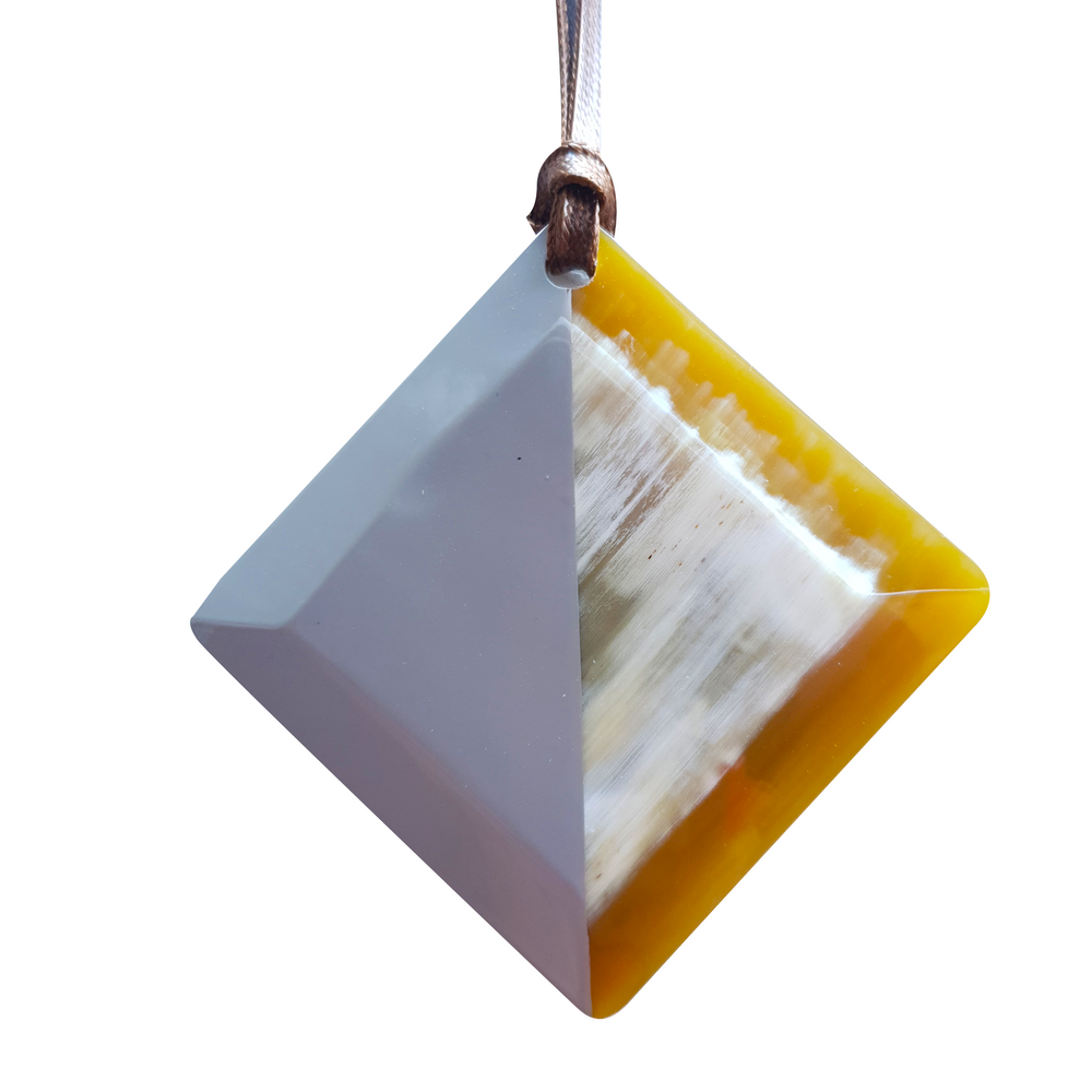 
                  
                    lozenge pendant with half natural horn and half painted ash on the light background, impressive gift for her
                  
                