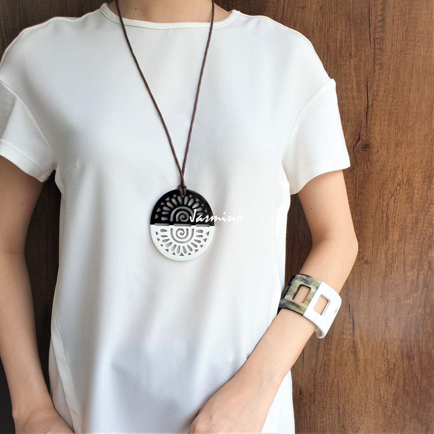A women is wearing pendant is designed with half natural horn and half brilliant white lacquer, unique gift for her