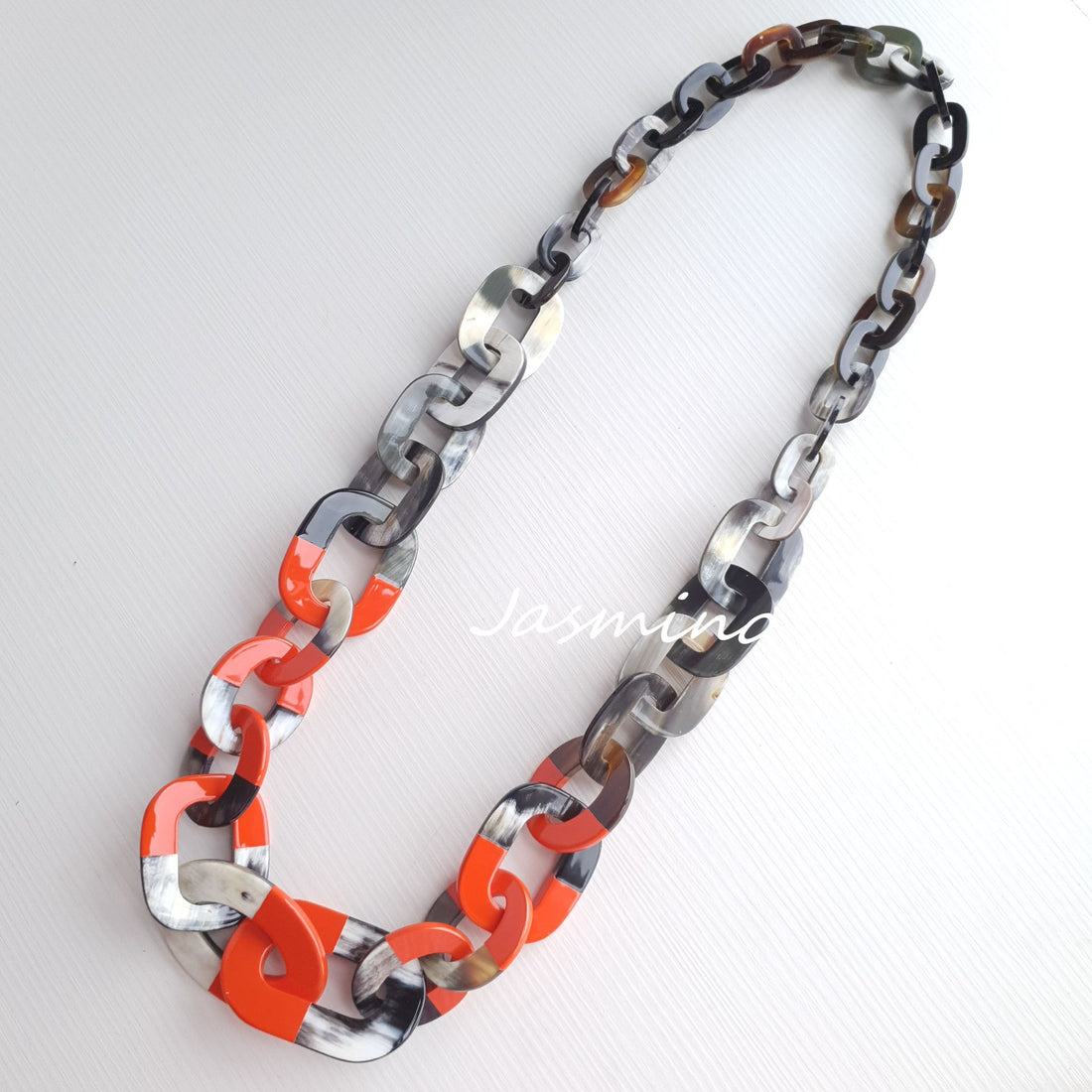 chain orange peel lacquer with dark buffalo horn necklace in natural light