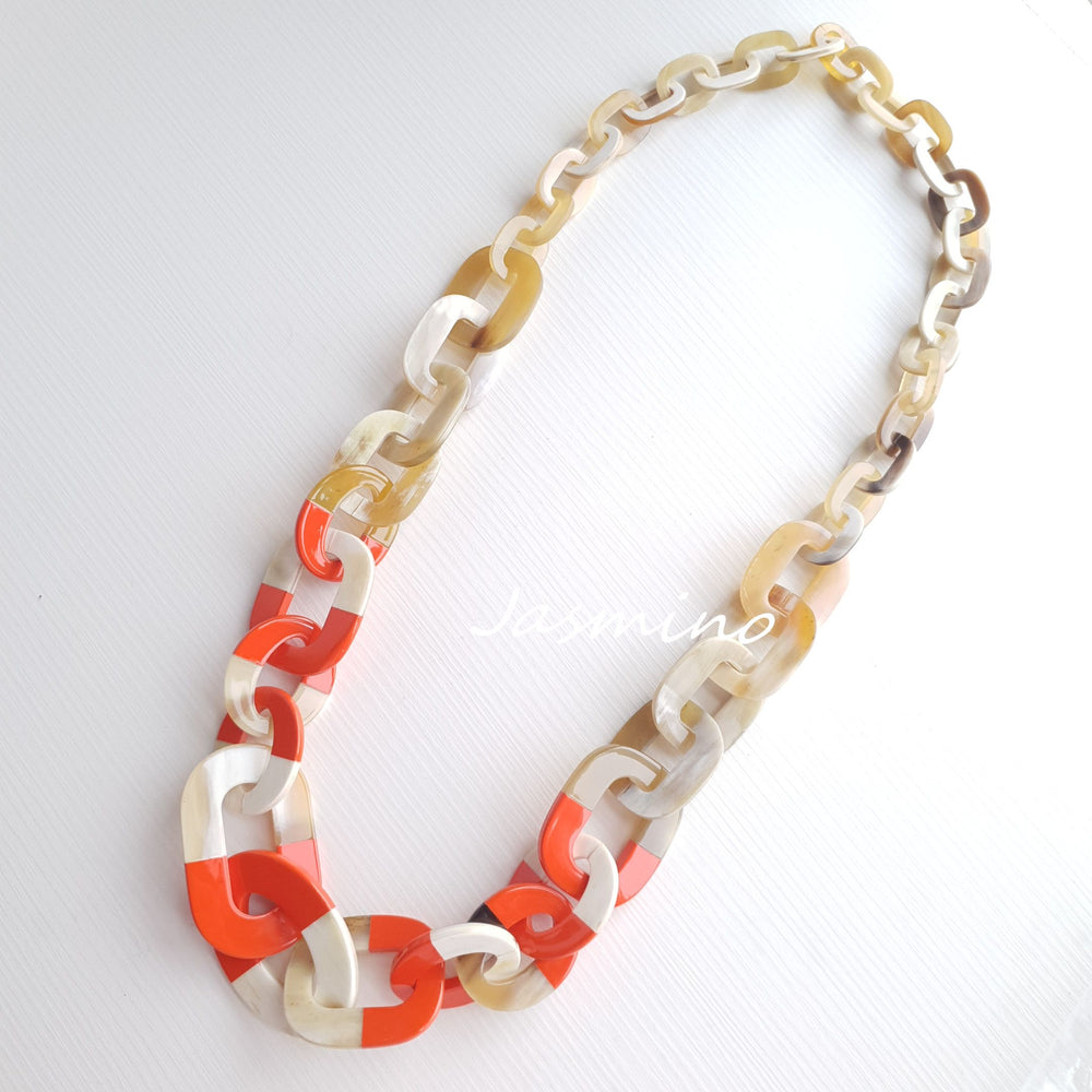
                  
                    chain orange peel lacquer with dark buffalo horn necklace in natural light
                  
                