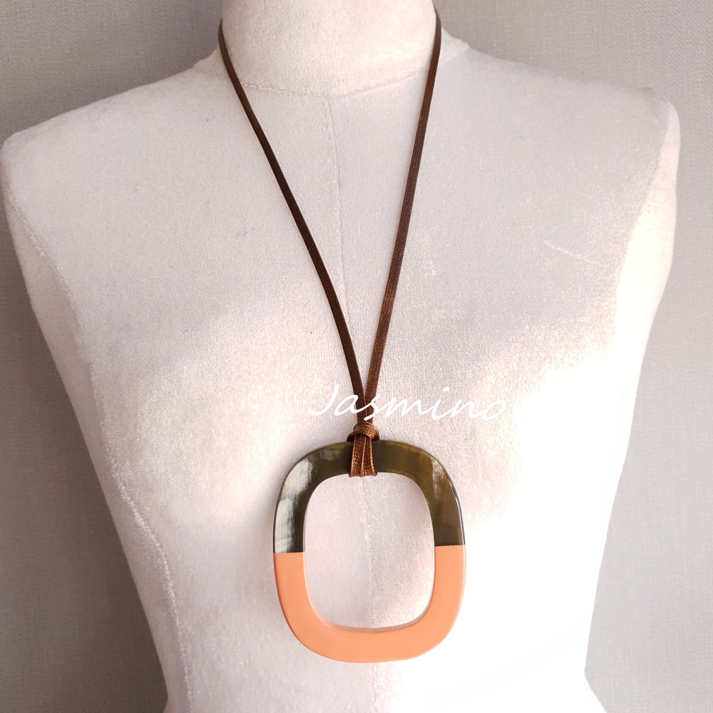 
                  
                    pendant is designed with the top half of a natural buffalo horn and the bottom half is painted salmon, unique gift for her
                  
                